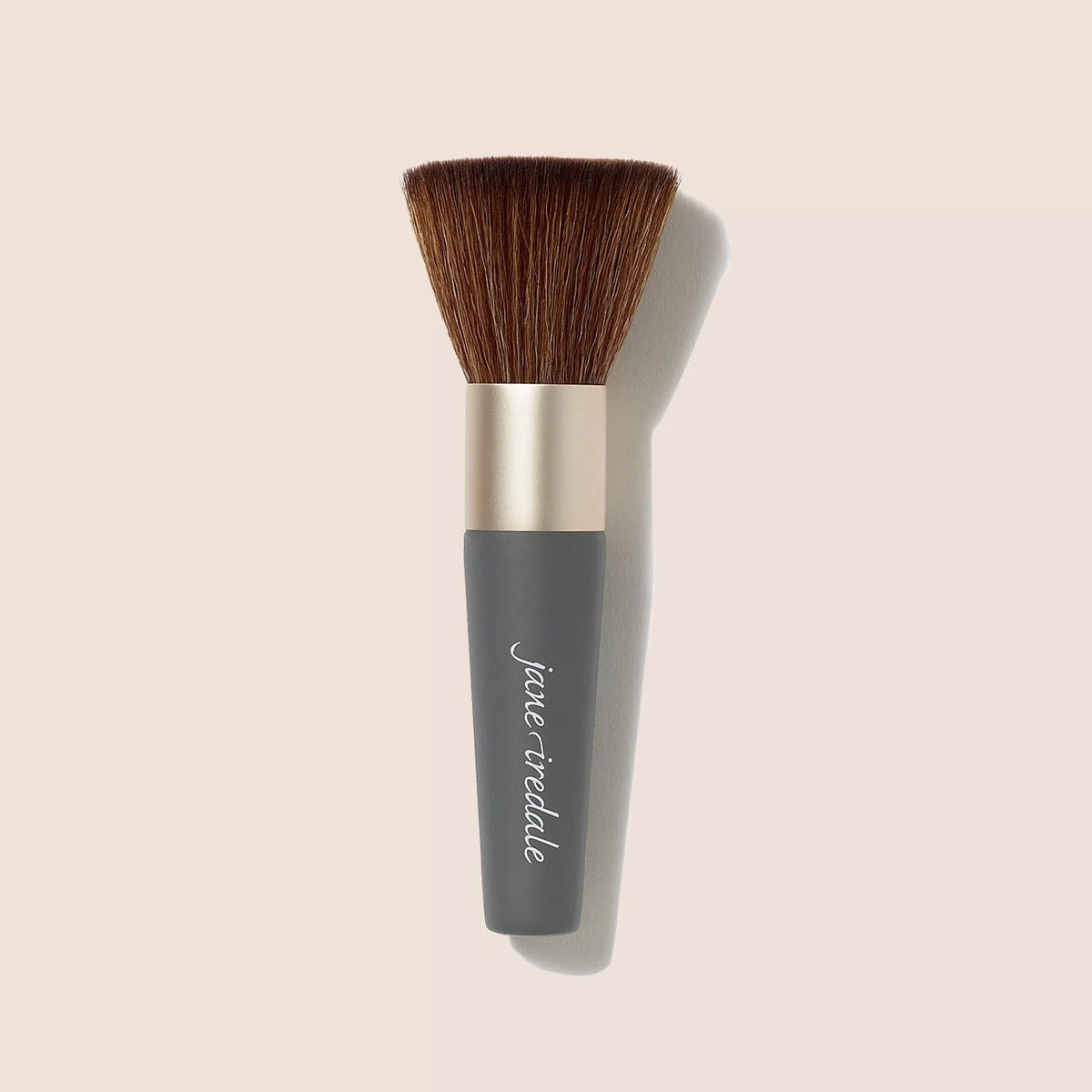 Compact makeup brush with brown bristles and dark gray handle.