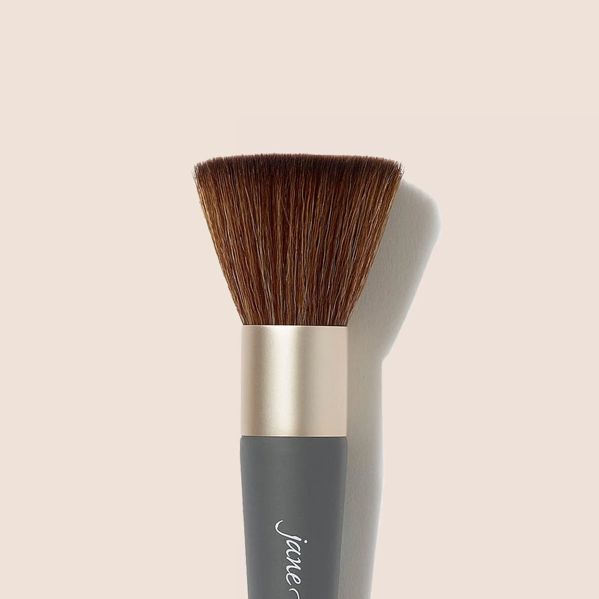 Makeup brush head with dense brown bristles and silver ferrule.